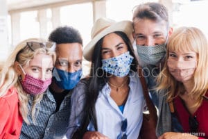 group of university students smiling at the camera with masks on