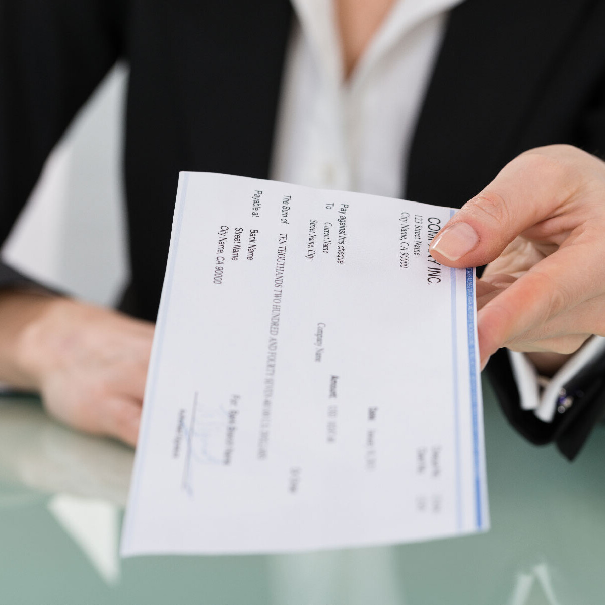 person handing over check