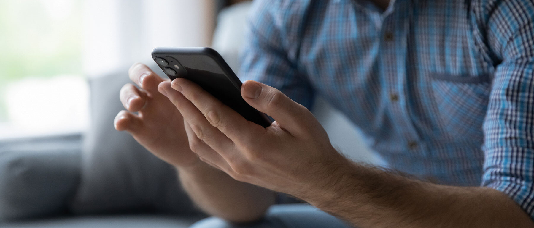 man looking at mobile phone